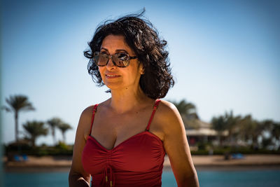 Portrait of woman against swimming pool