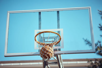 Low angle view of basketball hoop against sky