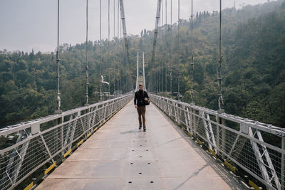 Man walking on footbridge