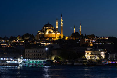 Illuminated buildings in city at night, suleymaniye mosque