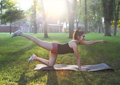Side view of woman exercising at park
