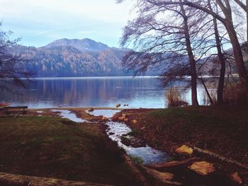 Scenic view of river and mountain against sky