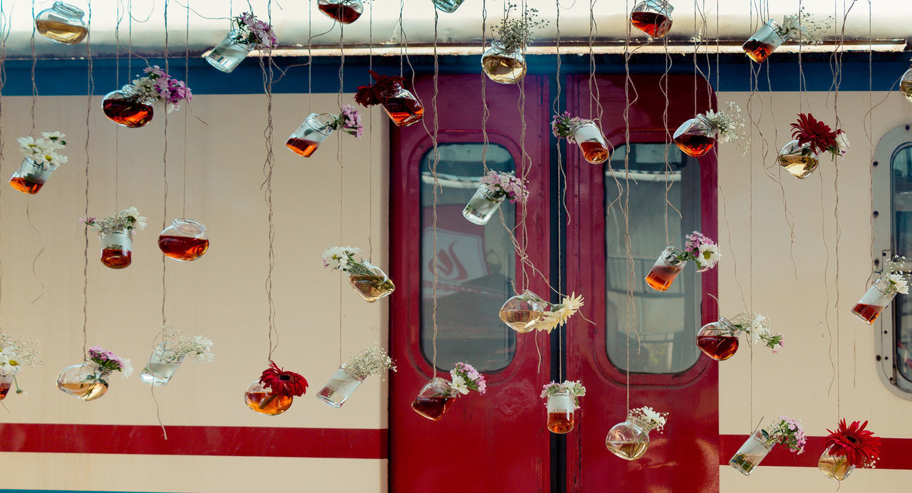 FULL FRAME SHOT OF MULTI COLORED DOOR HANGING ON BUILDING