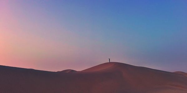 Scenic view of silhouette mountain against sky during sunset