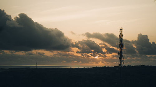 Silhouette tower against sky during sunset