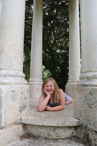 Portrait of a smiling young woman sitting outdoors