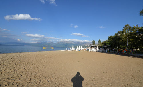 Scenic view of beach against blue sky