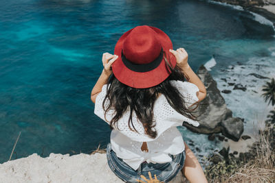 Young pretty asian woman feeling relax with mountain view at diamond beach in bali.