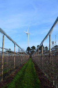 Windmill on field against sky