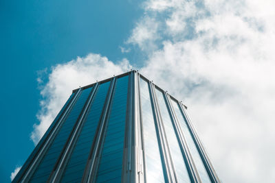 Low angle view of glass building against sky