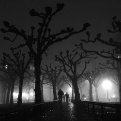 Blurred motion of people walking on road at night