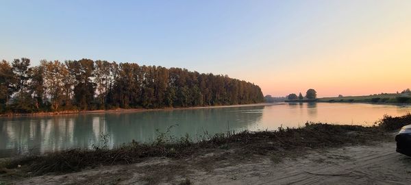 Scenic view of lake against sky during sunset