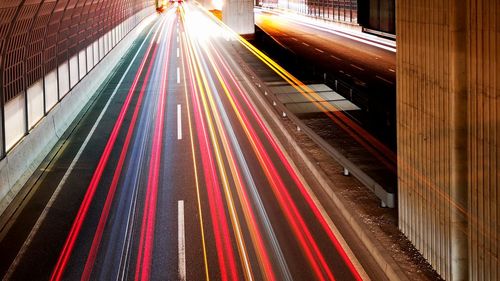 High angle view of light trails on road at night