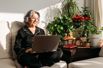 Young woman using laptop at home