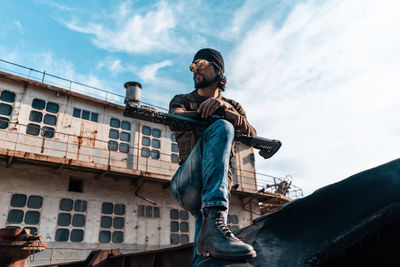 Low angle view of man standing against sky