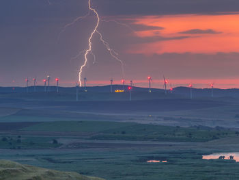 Scenic view of lightning against sky during sunset