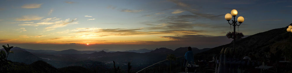 Panoramic view of silhouette mountains against sky during sunset