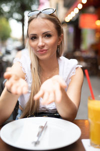 Portrait of smiling friends sitting at restaurant