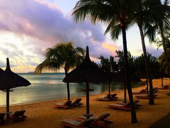 Scenic view of beach against cloudy sky