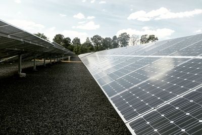 Solar panels on ground against sky