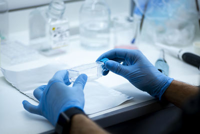 Midsection of doctor examining patient in laboratory