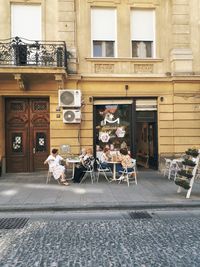 People standing on street against building