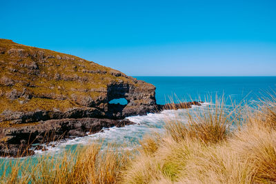 Scenic view of sea against clear blue sky