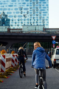 Woman riding bicycle on street