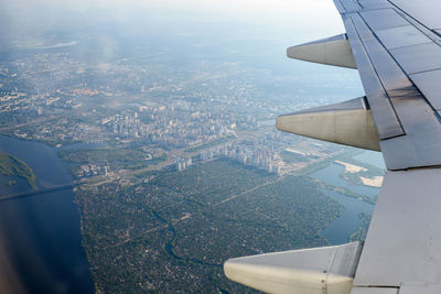 Cropped image of airplane flying over cityscape