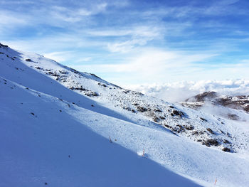 Scenic view of snow covered mountains against sky