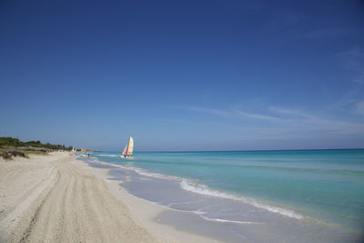 Scenic view of beach against cloudy sky