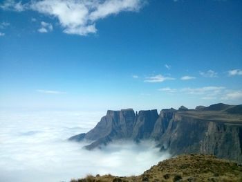 Scenic view of mountains against cloudy sky