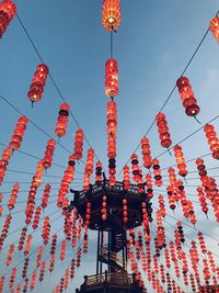 Low angle view of lanterns hanging against sky