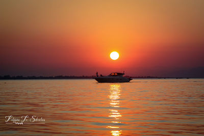 Scenic view of sea against orange sky