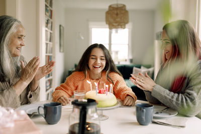 Happy girl enjoying and celebrating birthday with family at home