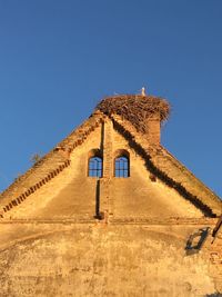 Low angle view of castle against clear blue sky