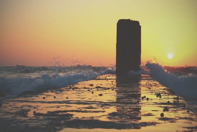 Scenic view of sea against orange sky