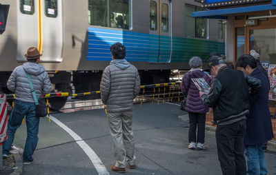 Rear view of people standing on bus