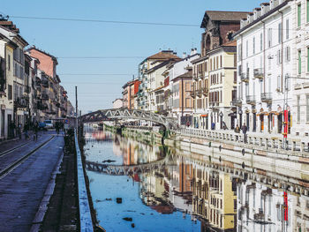 Reflection of buildings on street in city