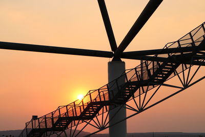 Low angle view of silhouette bridge against sky during sunset