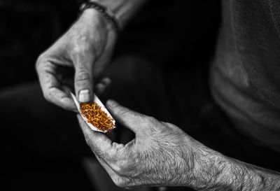 Close-up of man holding cigarette