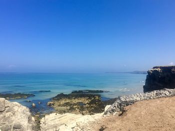 Scenic view of sea against blue sky