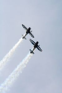 Low angle view of airshow against clear sky