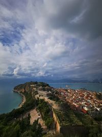 High angle view of townscape by sea against sky