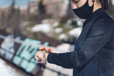 Midsection of woman standing against blurred background