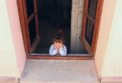 Girl looking at entrance to window