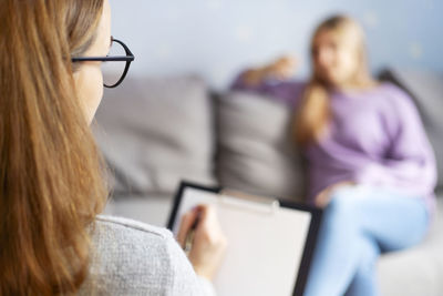 Portrait of woman using laptop at office