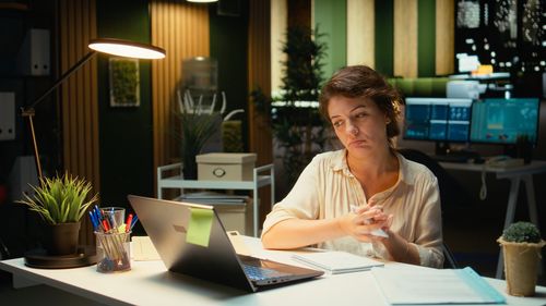 Young woman using laptop at cafe