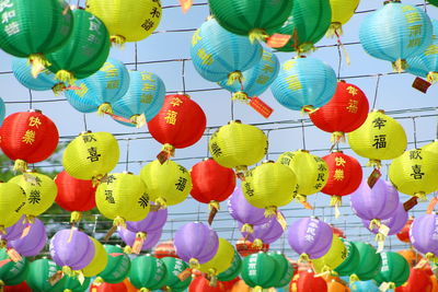 Low angle view of multi colored lanterns hanging on leaves