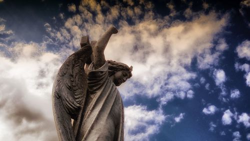 Low angle view of statue against sky